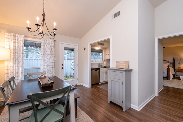 dining space with high vaulted ceiling, a chandelier, and dark hardwood / wood-style flooring