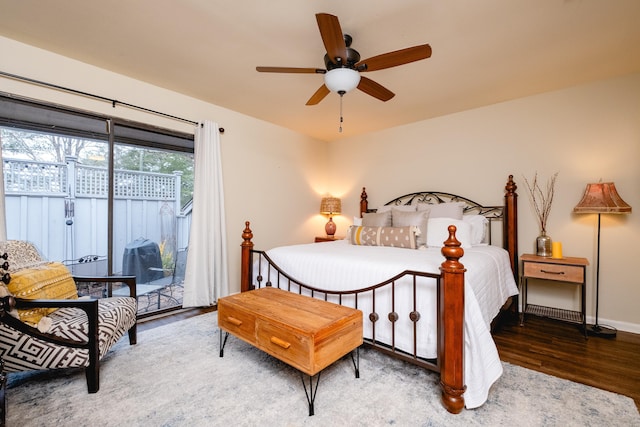 bedroom with access to exterior, dark hardwood / wood-style floors, and ceiling fan