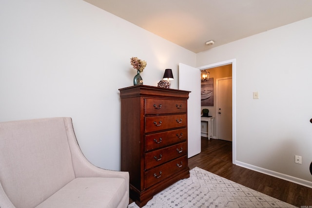 sitting room with dark hardwood / wood-style flooring