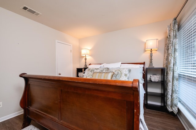 bedroom with dark hardwood / wood-style flooring