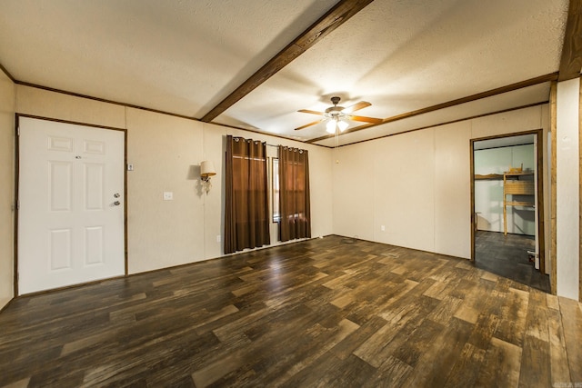 interior space featuring dark wood-type flooring, ceiling fan, ornamental molding, a textured ceiling, and beamed ceiling