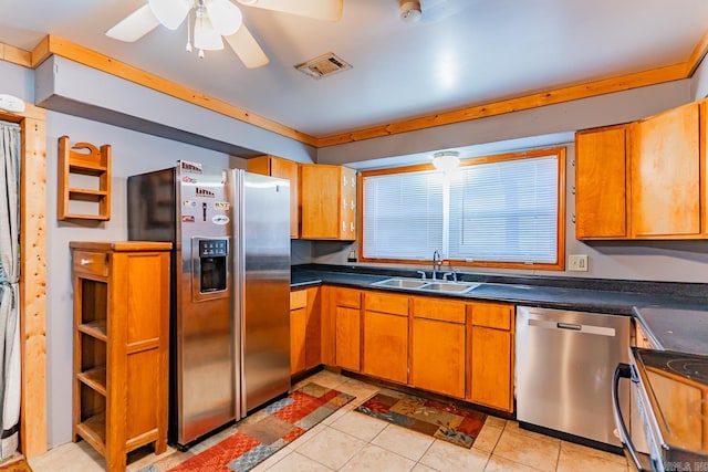 kitchen featuring light tile patterned flooring, ceiling fan, stainless steel appliances, and sink