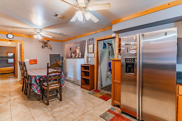 tiled dining area with ceiling fan