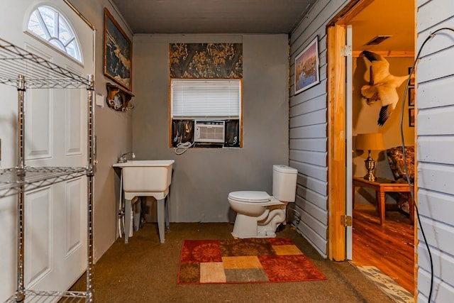 bathroom with cooling unit and toilet