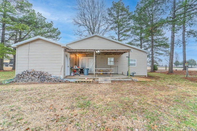 rear view of property with a lawn