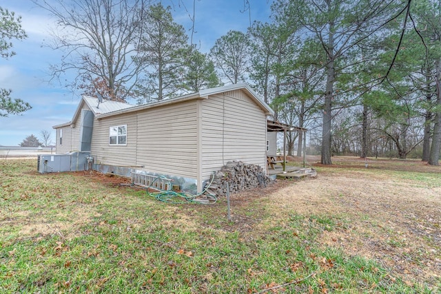 view of side of property with a lawn