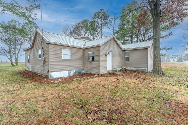 rear view of property with a yard and cooling unit