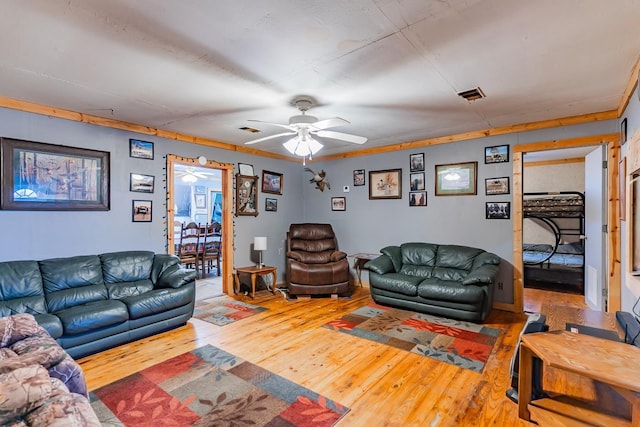 living room with hardwood / wood-style flooring and ceiling fan