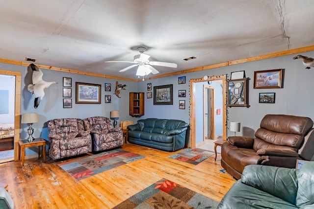 living room featuring hardwood / wood-style flooring and ceiling fan