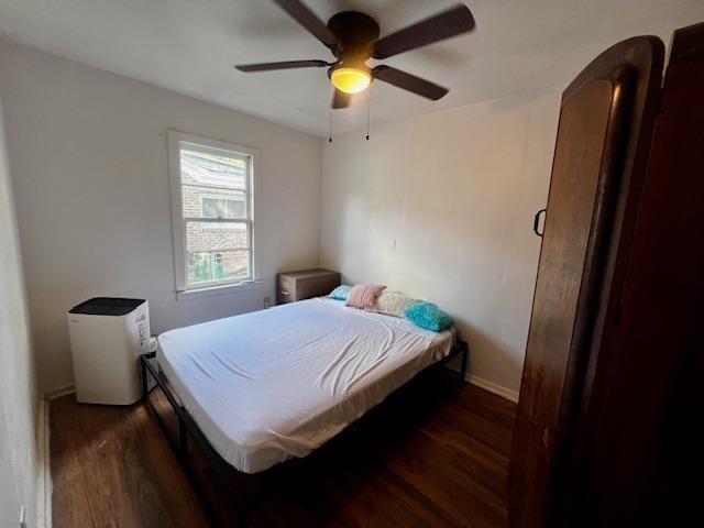 bedroom featuring dark wood-type flooring and ceiling fan