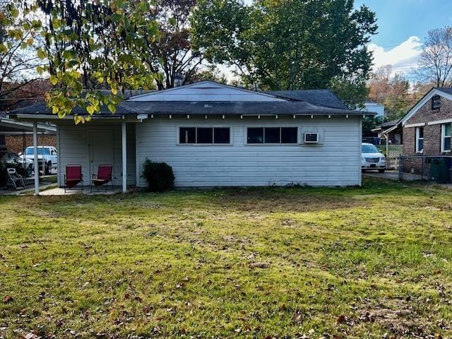 back of property featuring a lawn