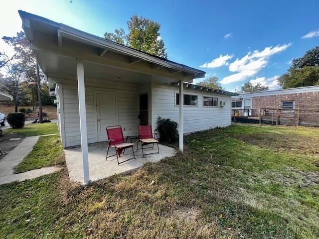 back of house with a yard and a patio area