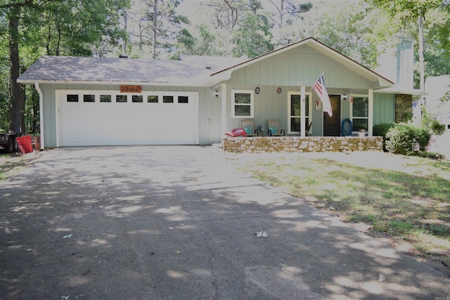 single story home featuring a porch and a garage