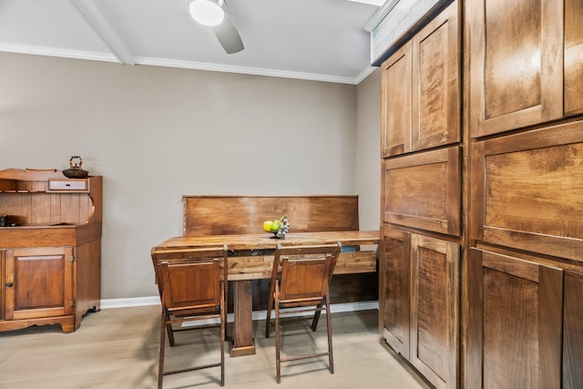 dining space featuring crown molding, light wood-type flooring, and ceiling fan