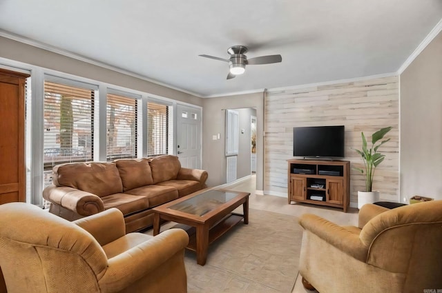 living room with ceiling fan, ornamental molding, light hardwood / wood-style floors, and wood walls