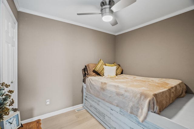 bedroom featuring ornamental molding, ceiling fan, and light wood-type flooring