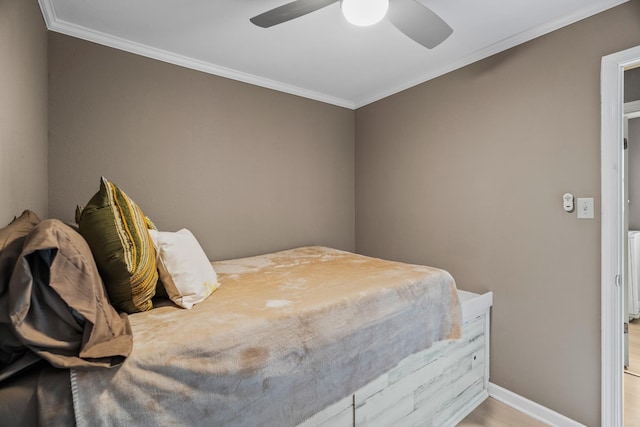 bedroom featuring crown molding, ceiling fan, and light hardwood / wood-style floors