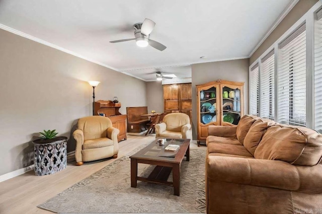 living room featuring crown molding, ceiling fan, and light wood-type flooring