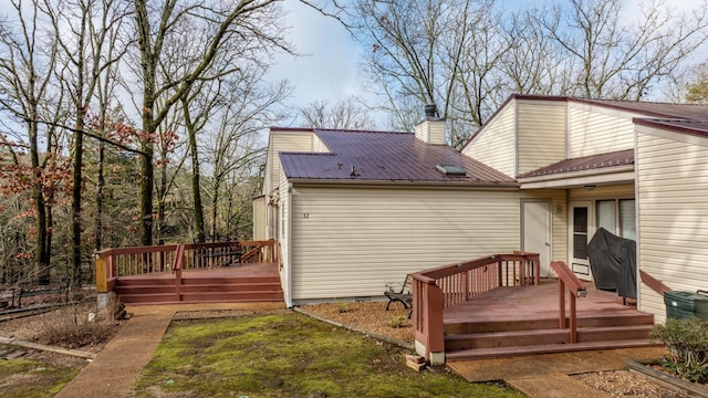 rear view of property featuring a deck