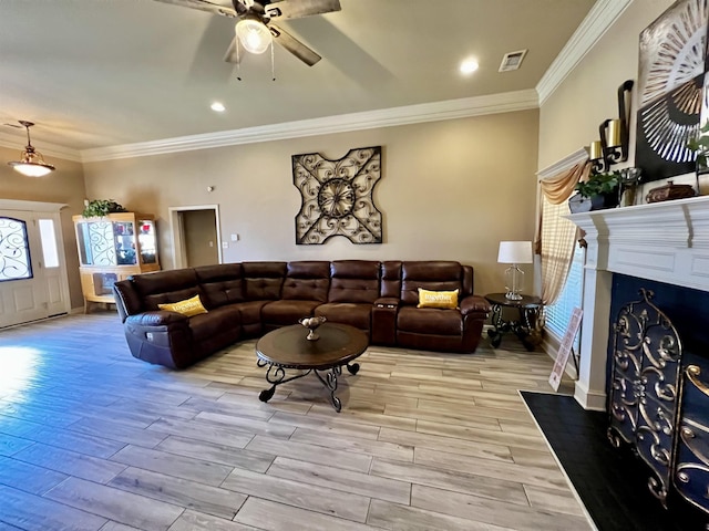 living room with ceiling fan and ornamental molding