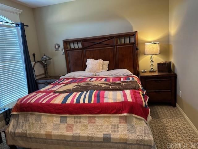 bedroom with baseboards and carpet flooring