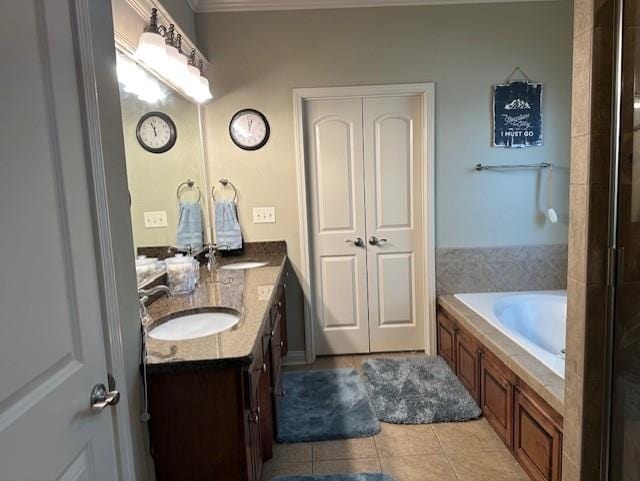 full bath with a shower with shower door, vanity, a bath, and tile patterned floors