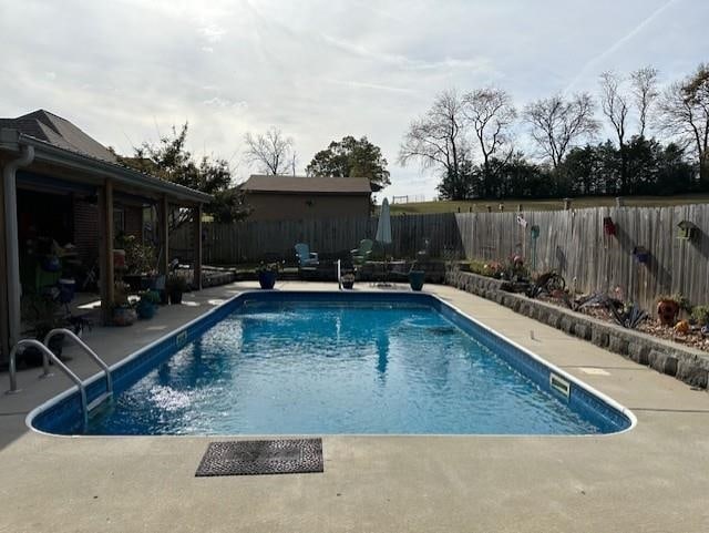 view of swimming pool featuring a fenced backyard, a fenced in pool, and a patio