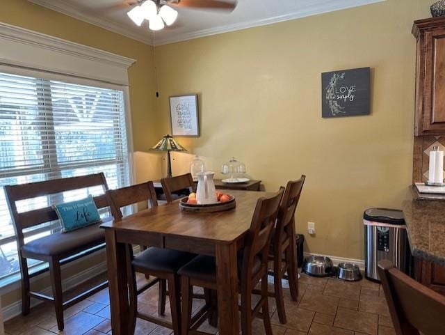 dining room with ornamental molding and ceiling fan