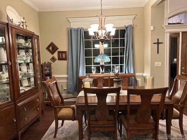 dining area featuring a chandelier, ornamental molding, and wood finished floors