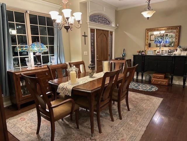 dining room featuring ornamental molding, hardwood / wood-style floors, and a chandelier