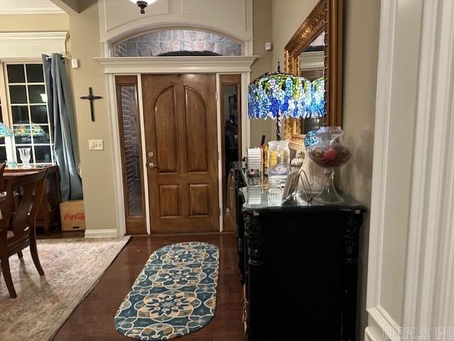 foyer with dark wood-style floors and baseboards