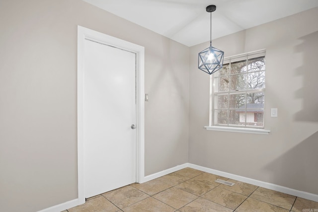 unfurnished dining area featuring light tile patterned flooring