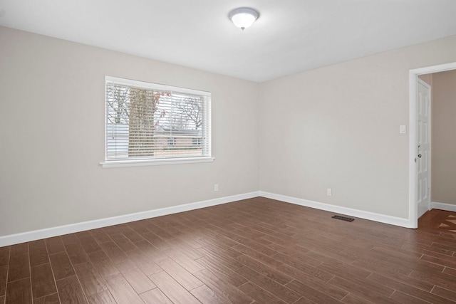 spare room featuring dark wood-type flooring