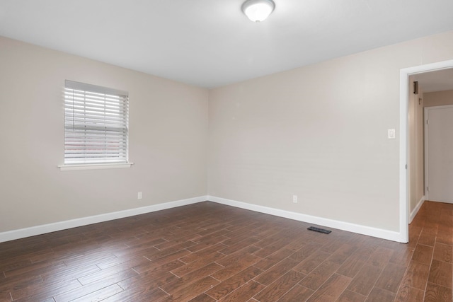 empty room with dark wood-type flooring