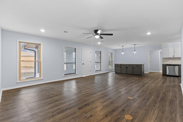 unfurnished living room with dark hardwood / wood-style floors and ceiling fan