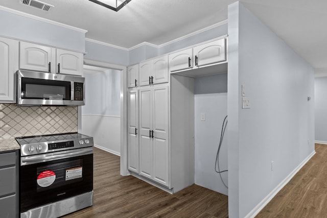 kitchen featuring white cabinetry, stainless steel appliances, dark hardwood / wood-style flooring, and backsplash