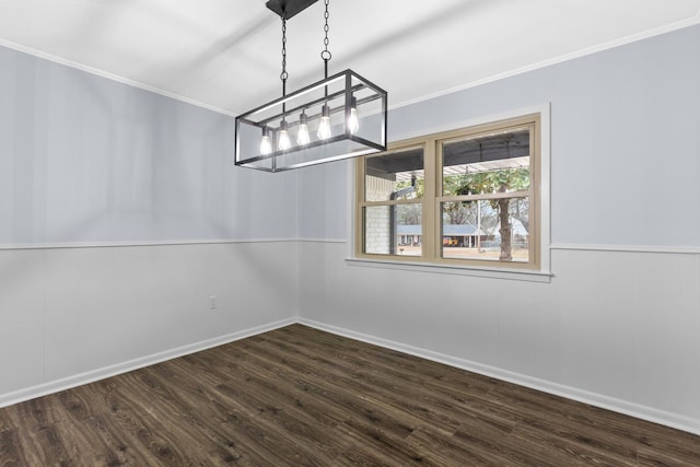 unfurnished dining area featuring ornamental molding and dark hardwood / wood-style floors