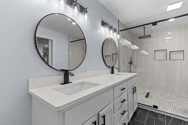 bathroom with vanity and tiled shower