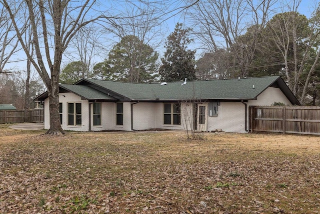 rear view of property featuring a yard and a patio