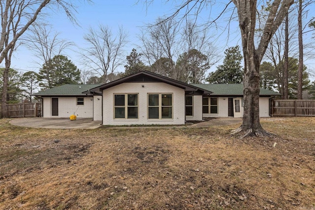 back of property with a patio