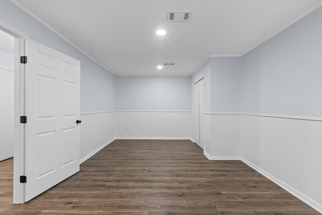 basement featuring crown molding and dark hardwood / wood-style floors