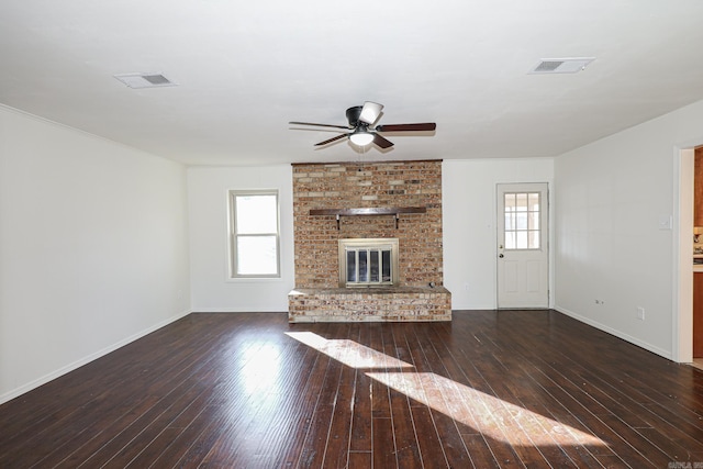 unfurnished living room featuring dark hardwood / wood-style flooring, a fireplace, and ceiling fan