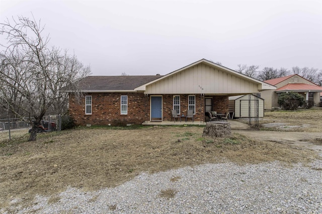 single story home featuring a storage shed