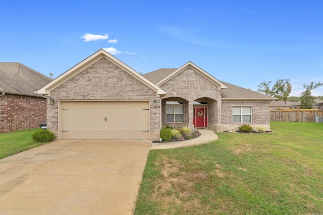 view of front of property with a garage and a front yard