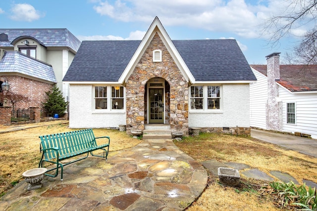 tudor home with a patio