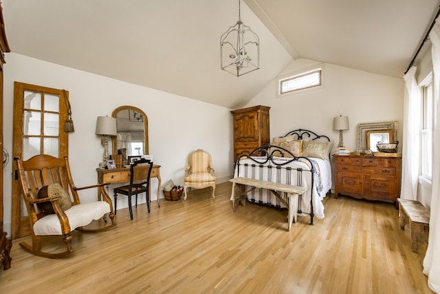 bedroom featuring lofted ceiling with beams, light hardwood / wood-style floors, and multiple windows