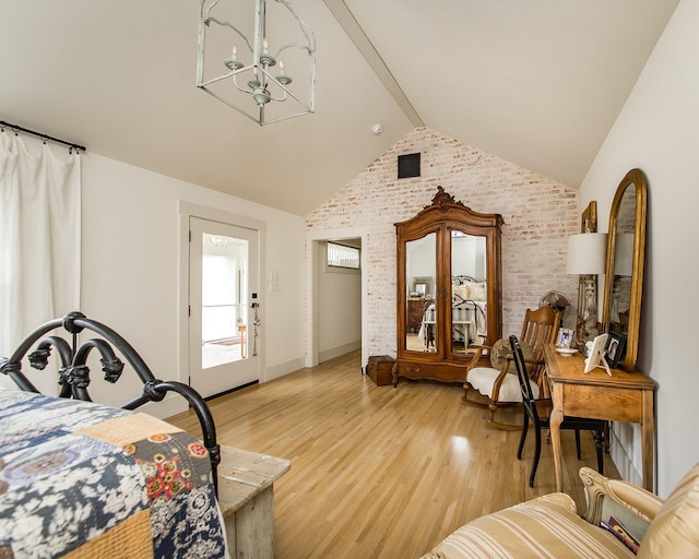 bedroom featuring vaulted ceiling with beams, a notable chandelier, light hardwood / wood-style floors, and brick wall