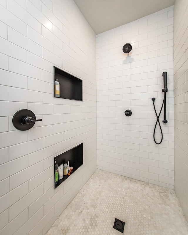 bathroom with tiled shower