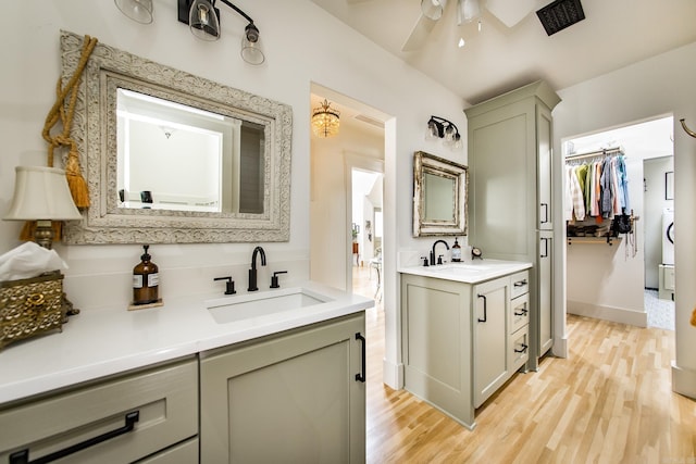 bathroom featuring ceiling fan, wood-type flooring, and vanity