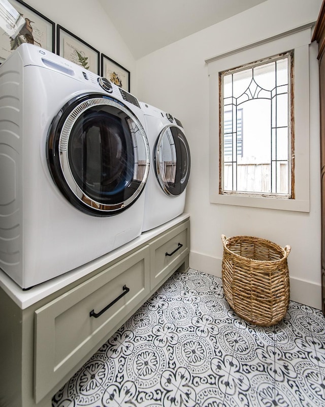 laundry room with light tile patterned flooring and separate washer and dryer